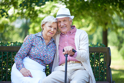 Romantic senior couple relaxed on the park bench