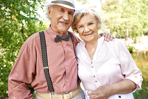 Elderly couple in smart casual-wear  in natural environment in summer