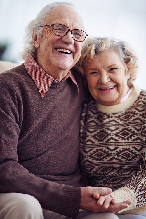 Ecstatic seniors in sweaters laughing