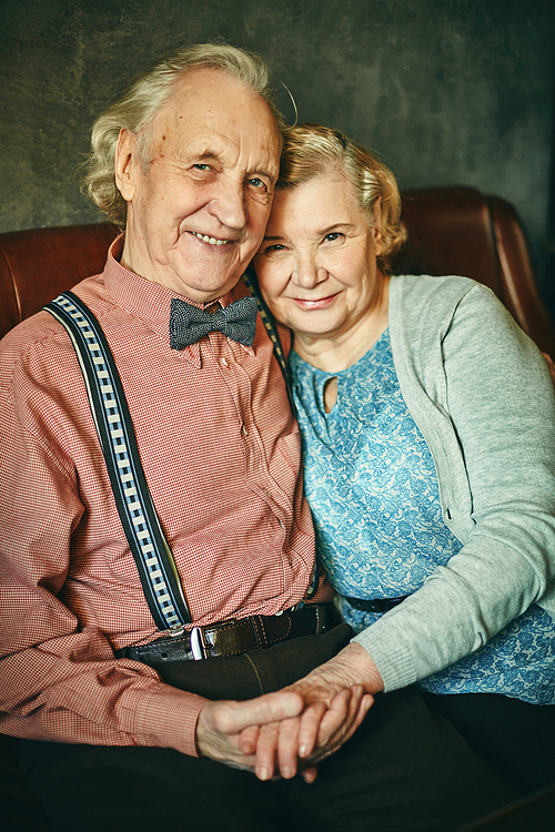 Portrait of happy senior couple in elegant clothes