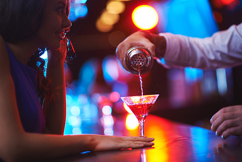 Young woman waiting for her martini in the bar