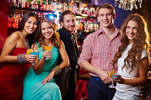 Beautiful people drinking cocktails in nightclub