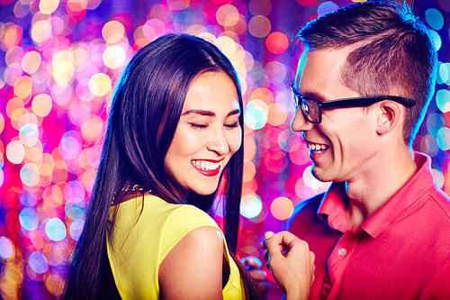 Cheerful couple laughing at party
