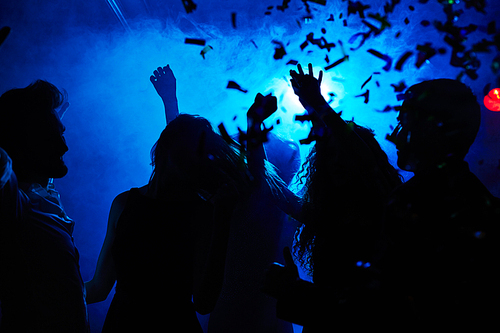 Silhouettes of people clubbing at night