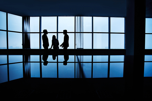 Three people meeting late in office