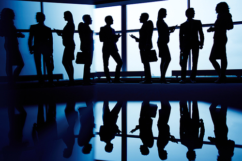 Interacting business partners standing by window