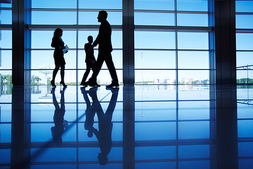 Office workers passing through office building