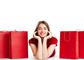 Young shopper  between red paperbags