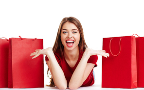 Ecstatic young woman  between red paperbags