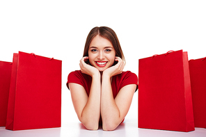 Beautiful woman smiling among shopping bags