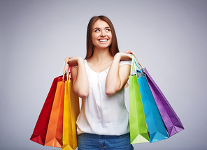 Satisfied consumer carrying multi-color paperbags