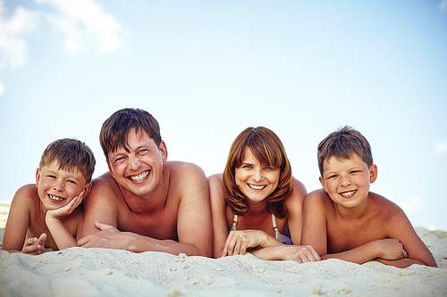 Happy family  while relaxing on sandy beach