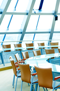 Empty conference hall with round table and chairs around it