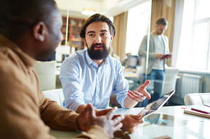 Young businessman explaining his idea to colleague