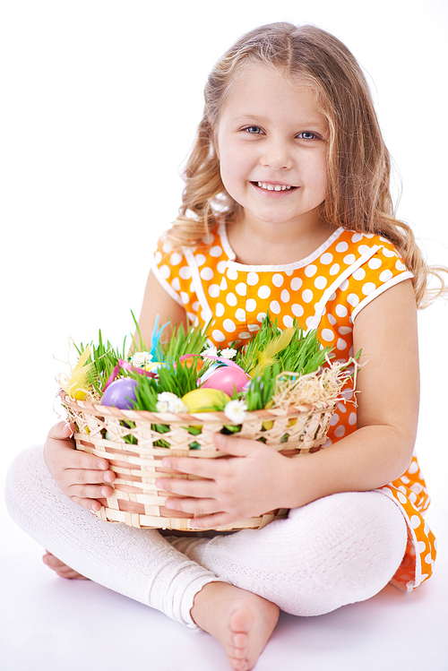 Portrait of a cute girl with basket full of eggs