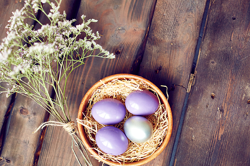 Still life of purple eggs and flowers