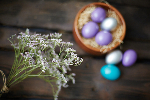 Close-up of wildflowers against Easter eggs