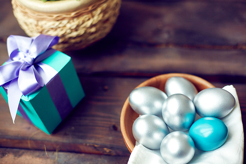 Silver eggs at a gift box