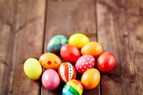 Painted Easter eggs on wooden table