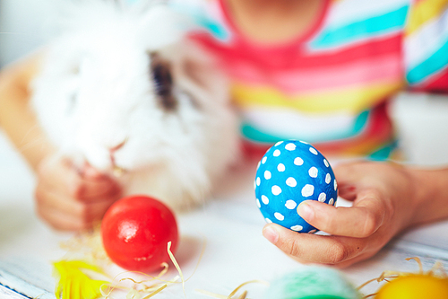 Girl holding a spotted blue Easter egg