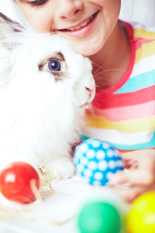 Little girl embracing a cute little rabbit