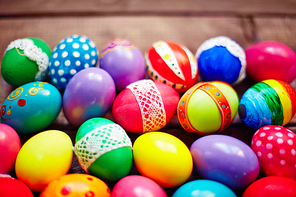 Colorful Easter eggs on wooden background