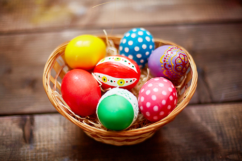 Group of decorative Easter eggs in small basket