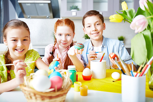 Group of children painting Easter eggs