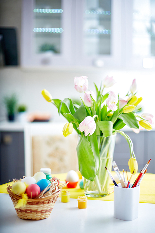 Vase with tulips and colored eggs