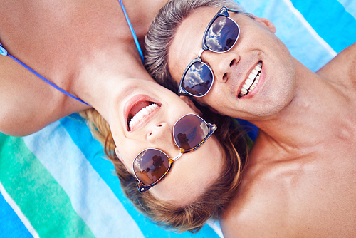 Young couple in sunglasses  while relaxing at summer resort