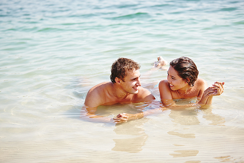 Happy young couple relaxing in water