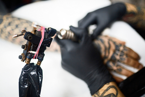 Tattoo machinery being used by master of tattooing