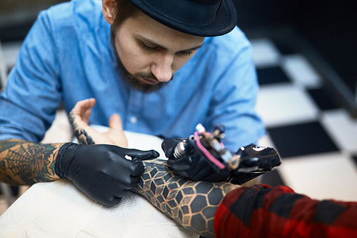 Creative adornment being drawn by professional tattooer