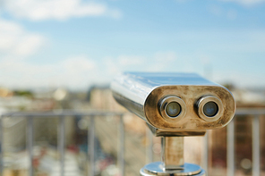 Background image of coin operated binoculars standing on rooftop viewing platform pointed over old European city