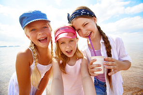 Cheerful girls  on background of sea and sky