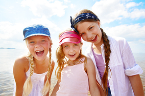 Adorable girls laughing during beach vacation