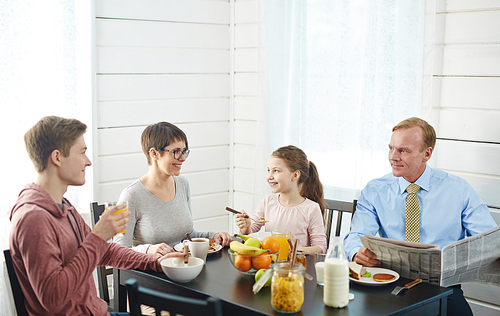 healthy family of four having  food for breakfast