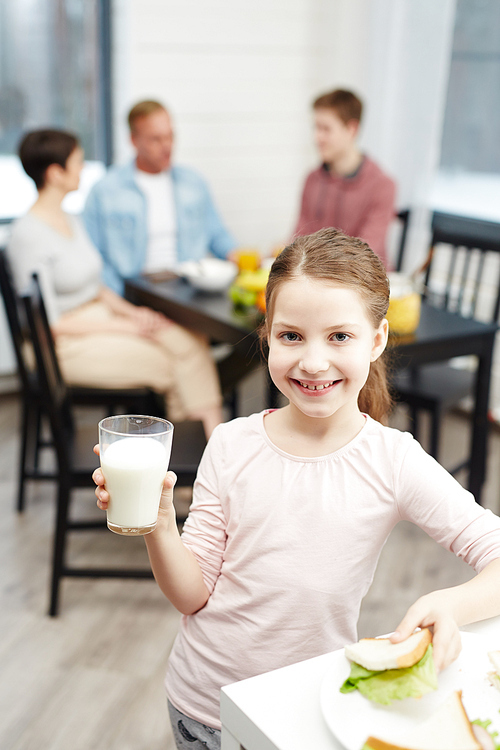 Healthy girl with glass of milk and sandwich 