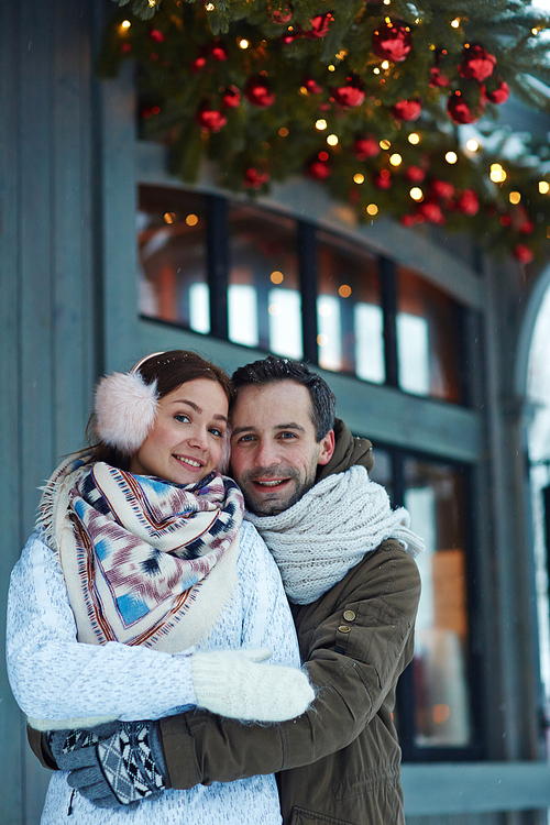 Happy man embracing his wife on winter day