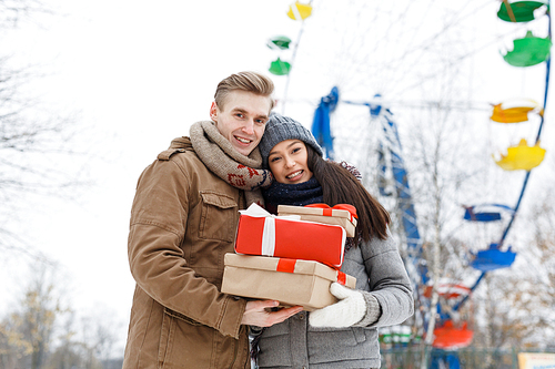 Affectionate dates with giftboxes spending time in amusement park