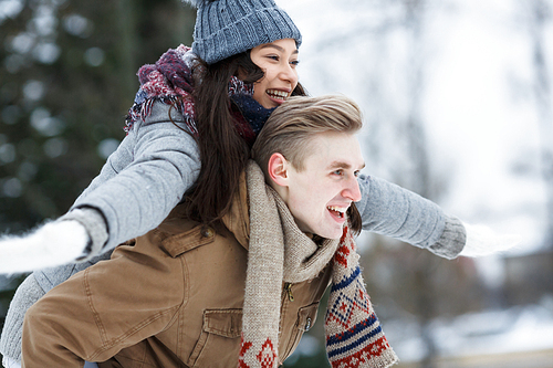 Side view of laughing dates in winterwear