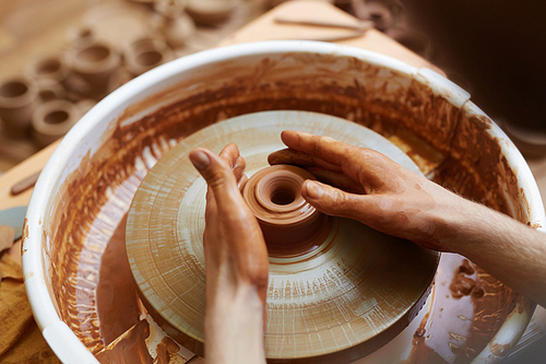 Hands of artisan during pottery work