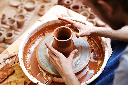 Fireclay jug rotating in pottery-wheel