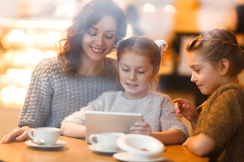 Restful family of three browsing in the net in cafe