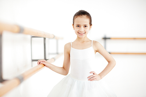 Happy little ballerina  while training before stage performance