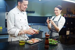 Chef of modern restaurant recording video recipe for his blog