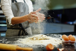 Bake-house worker making dough for bread or pastry