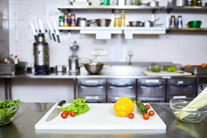 Fresh vegs and knife on table of restaurant kitchen