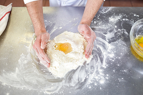 Baker starts kneading dough on table