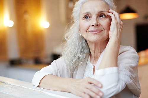 Grey-haired pensioner thinking of something pleasant at leisure